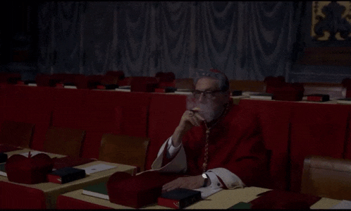 a man in a red robe smoking a cigarette