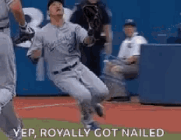 a baseball player is jumping in the air while catching a ball on a baseball field .