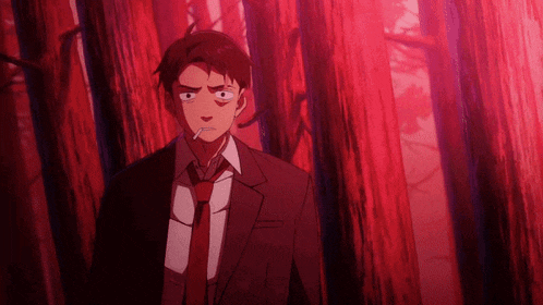 a man in a suit and tie is smoking a cigarette in a dark forest
