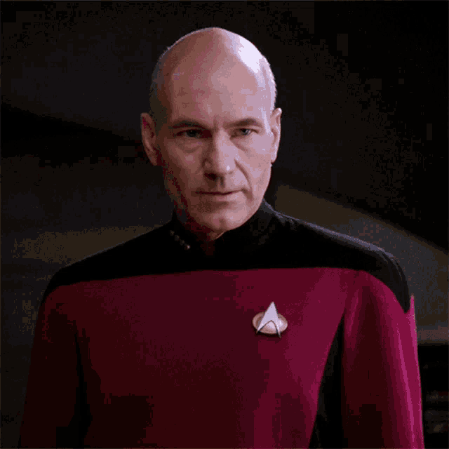 a man wearing a star trek uniform has a badge on his chest