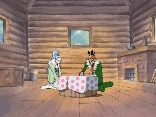 a man and a woman sit at a table in a room