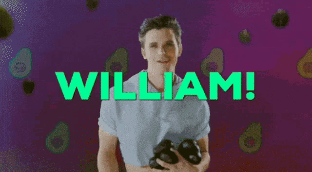 a man holding a camera in front of a green sign that says " william "