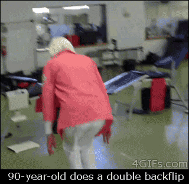 an older woman in a red jacket does a double backflip