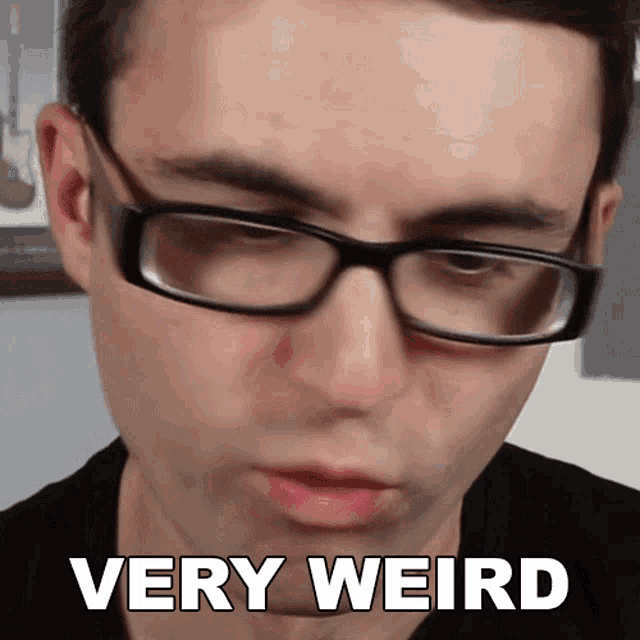 a man wearing glasses with the words very weird written on his face
