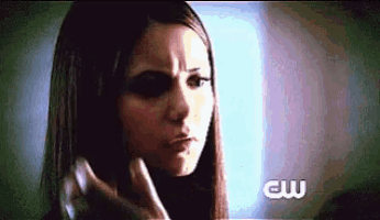 a close up of a woman 's face with a cw logo in the corner .