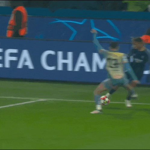 a soccer player with the number 23 on his jersey kicks the ball