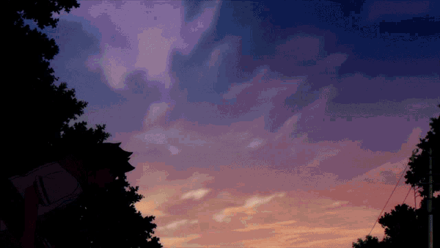 a sunset with a purple and orange sky and trees