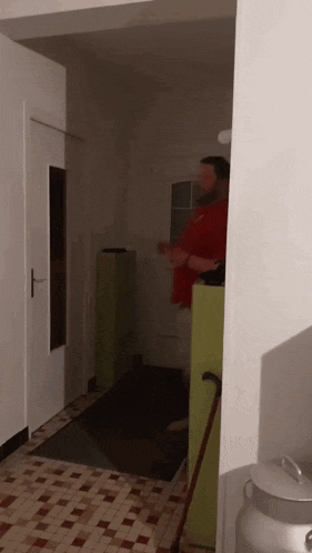 a man with a cane is standing in a hallway