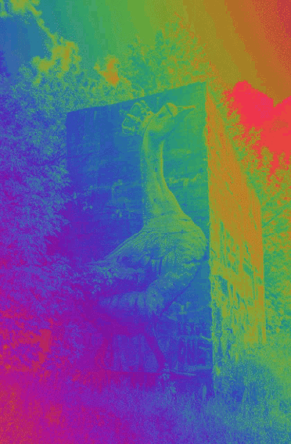 a rainbow colored background with a statue of a giraffe