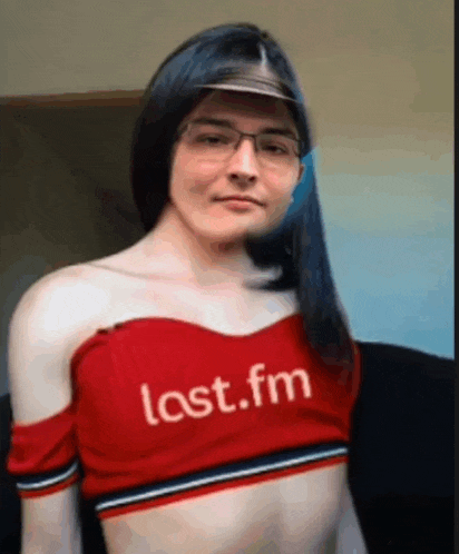 a woman wearing glasses and a red crop top that says lost.fm