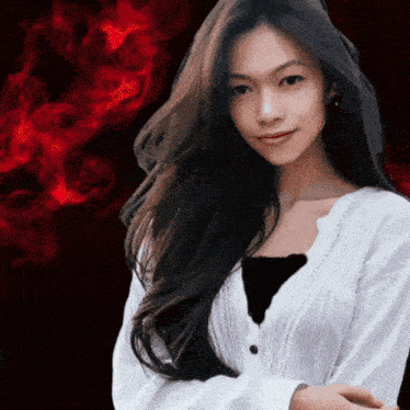 a woman with long black hair wearing a white sweater