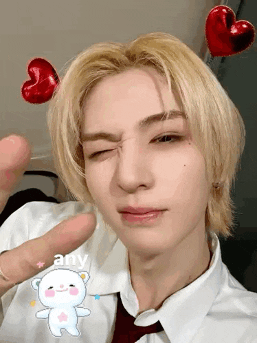 a close up of a person 's face with a teddy bear and hearts on their head