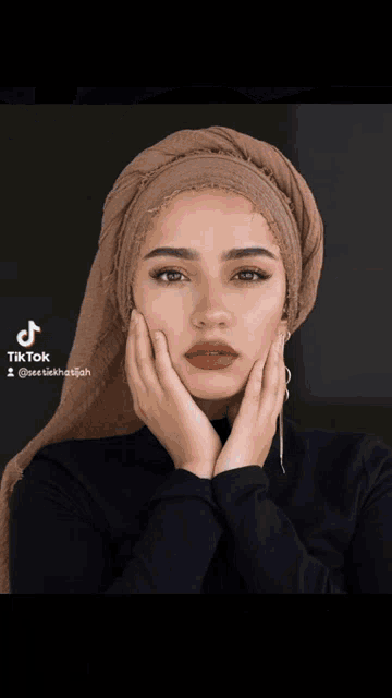 a woman wearing a hijab has tiktok written on the bottom