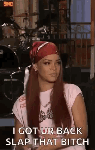 a woman with long red hair is wearing a bandana and a pink shirt and says i got urback slap that bitch .
