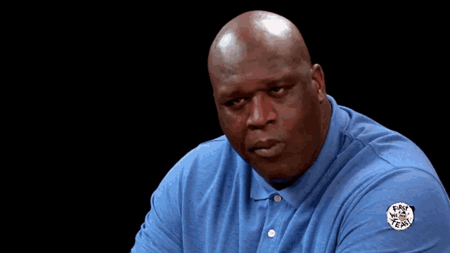 a man wearing a blue shirt has a patch on his sleeve that says easy way