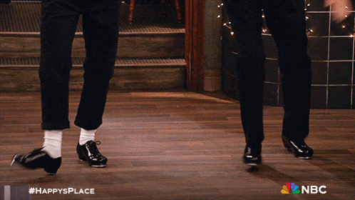 two men are dancing on a wooden floor and the nbc logo is visible
