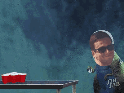 a man wearing sunglasses and a shirt that says jib jab is playing beer pong