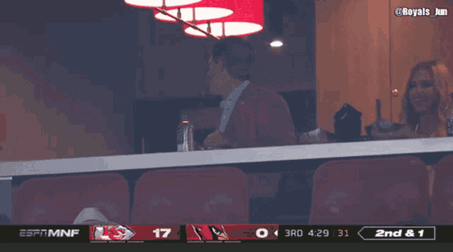 espn mnf shows a man and woman watching a football game