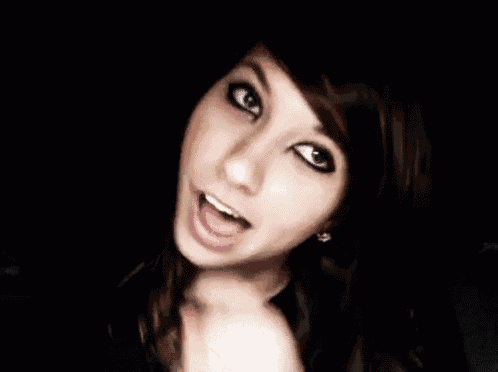 a close up of a girl 's face with a black background