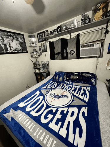a bed with a dodgers national league blanket