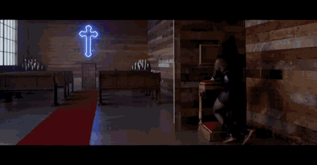 a church with a glowing cross on the wall