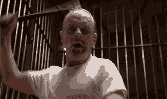 a pixelated image of a man in a white shirt that says ' prisoner ' on it