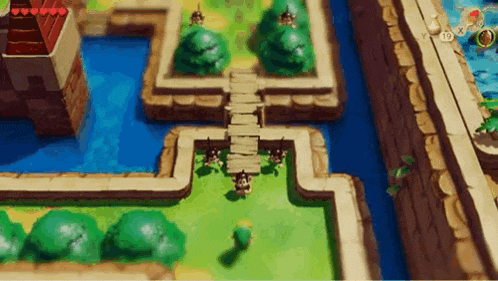 a video game is being played on a computer and a person is walking across a wooden bridge .