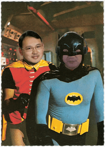 a man in a batman costume is standing next to another man in a robin costume