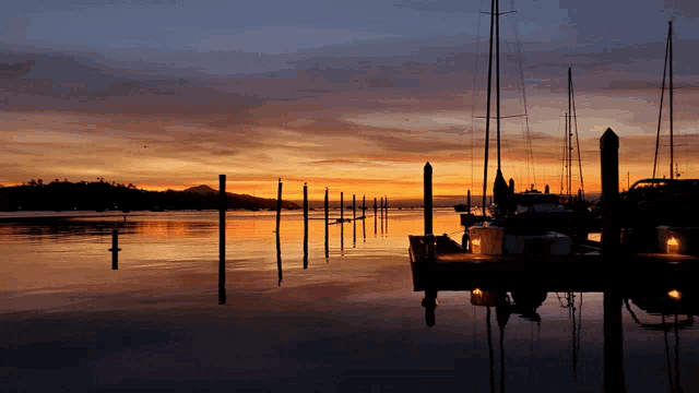 a sunset over a harbor with boats docked