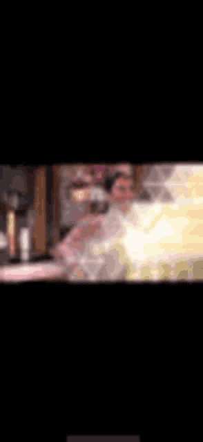 a blurry picture of a person standing in a room with a light coming out of it .