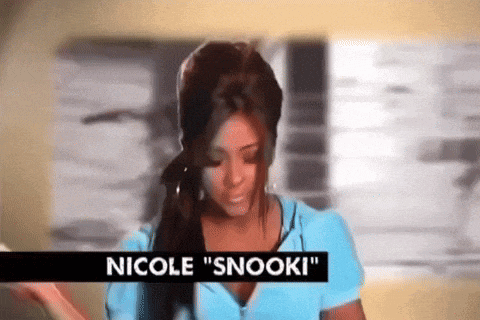 a woman in a blue shirt with the name nicole snooki on it