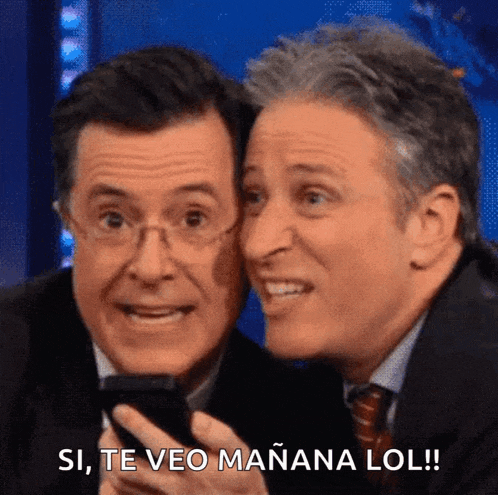 two men are looking at a cell phone and one of them says si te veo mañana lol