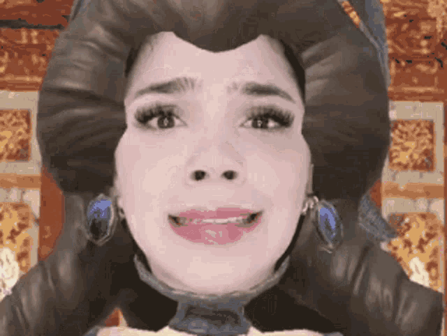 a close up of a woman 's face with a wig on