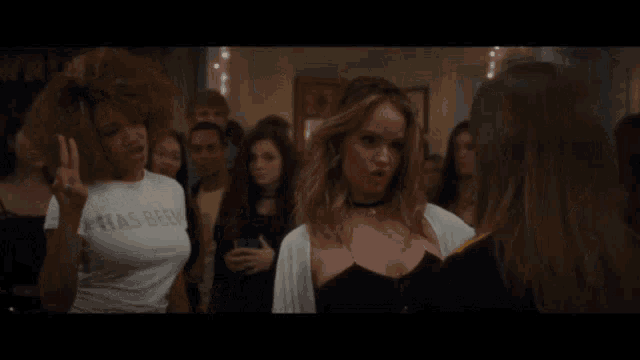 two women are standing next to each other and one of them is wearing a shirt that says has been .