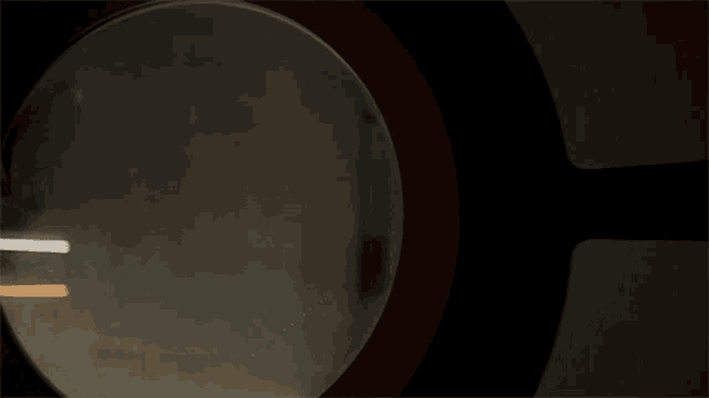 a view of the moon through a telescope with a red circle around it