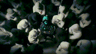 a man in a green hoodie is surrounded by other people