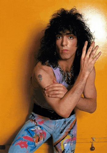 a man with a tattoo on his arm is posing for a photo