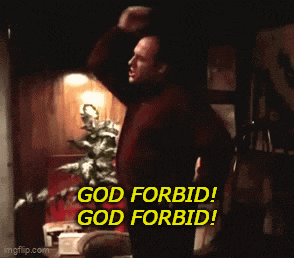 a man in a red shirt is standing in a dark room and says " god forbid "