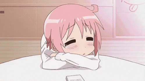 a cartoon girl with pink hair is sitting at a table with her head on her arms .