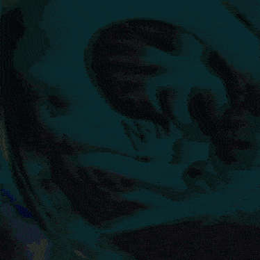 a blurry picture of a person 's face with the letter n on the bottom