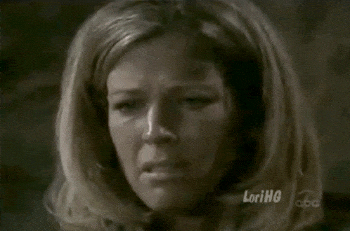 a close up of a woman 's face with lorihg on the bottom left