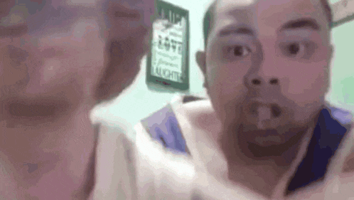 a man and a woman are making funny faces while standing next to each other .