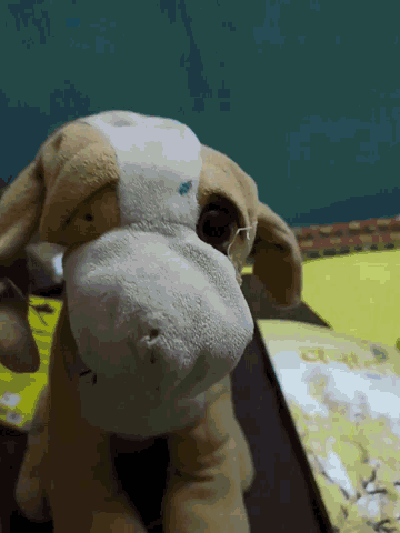 a stuffed animal with a blue stain on its nose
