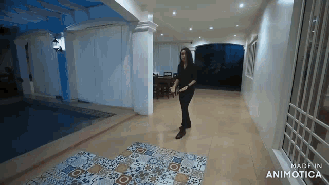 a video of a woman dancing in a room with the words made in animatica on the bottom