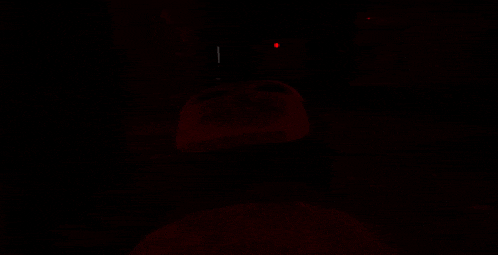 a dark room with a red light shining on the floor