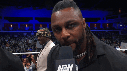 a man talking into a microphone with the words " i 'm a beat you down " below him