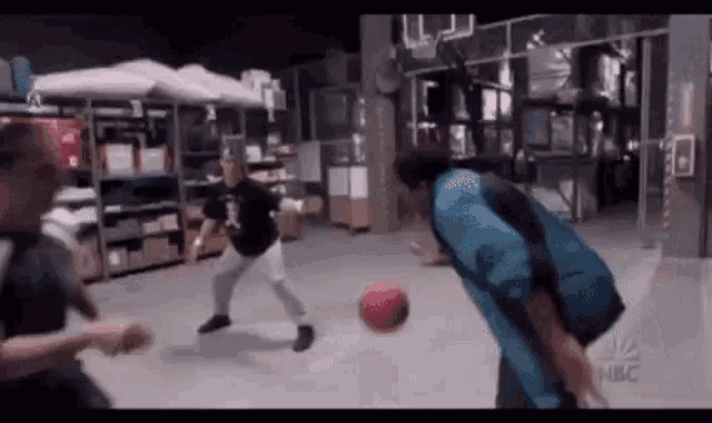 a group of people are playing basketball in a room .