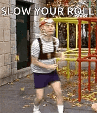a man in a striped shirt and shorts is dancing in front of a playground .