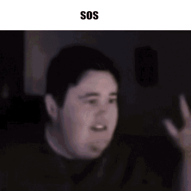 a close up of a boy 's face with the words `` sos '' on the bottom .