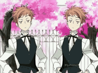 two anime characters are standing next to each other in front of a fence and cherry blossom trees .